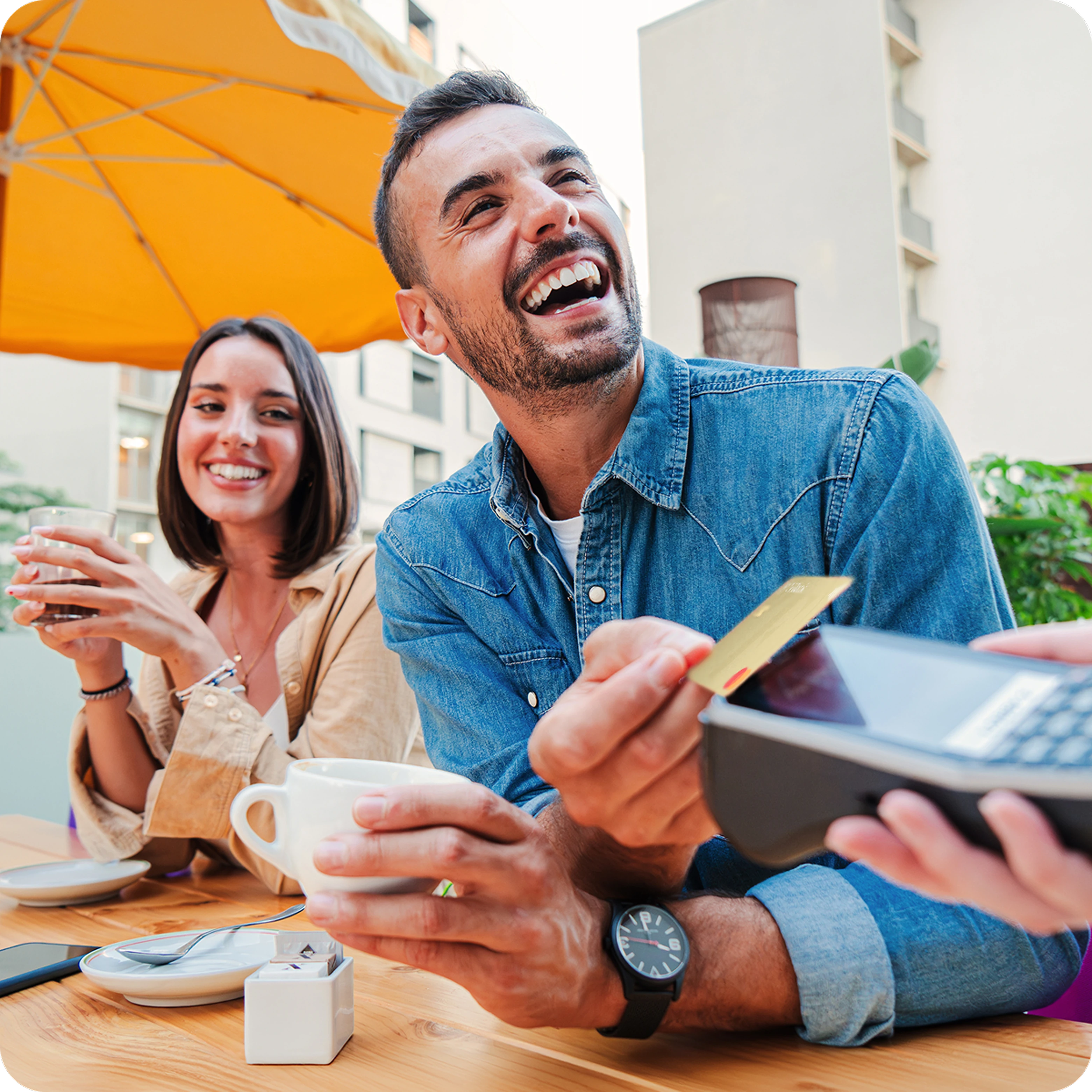 man smiling on restaurant paying with tf bank mastercard